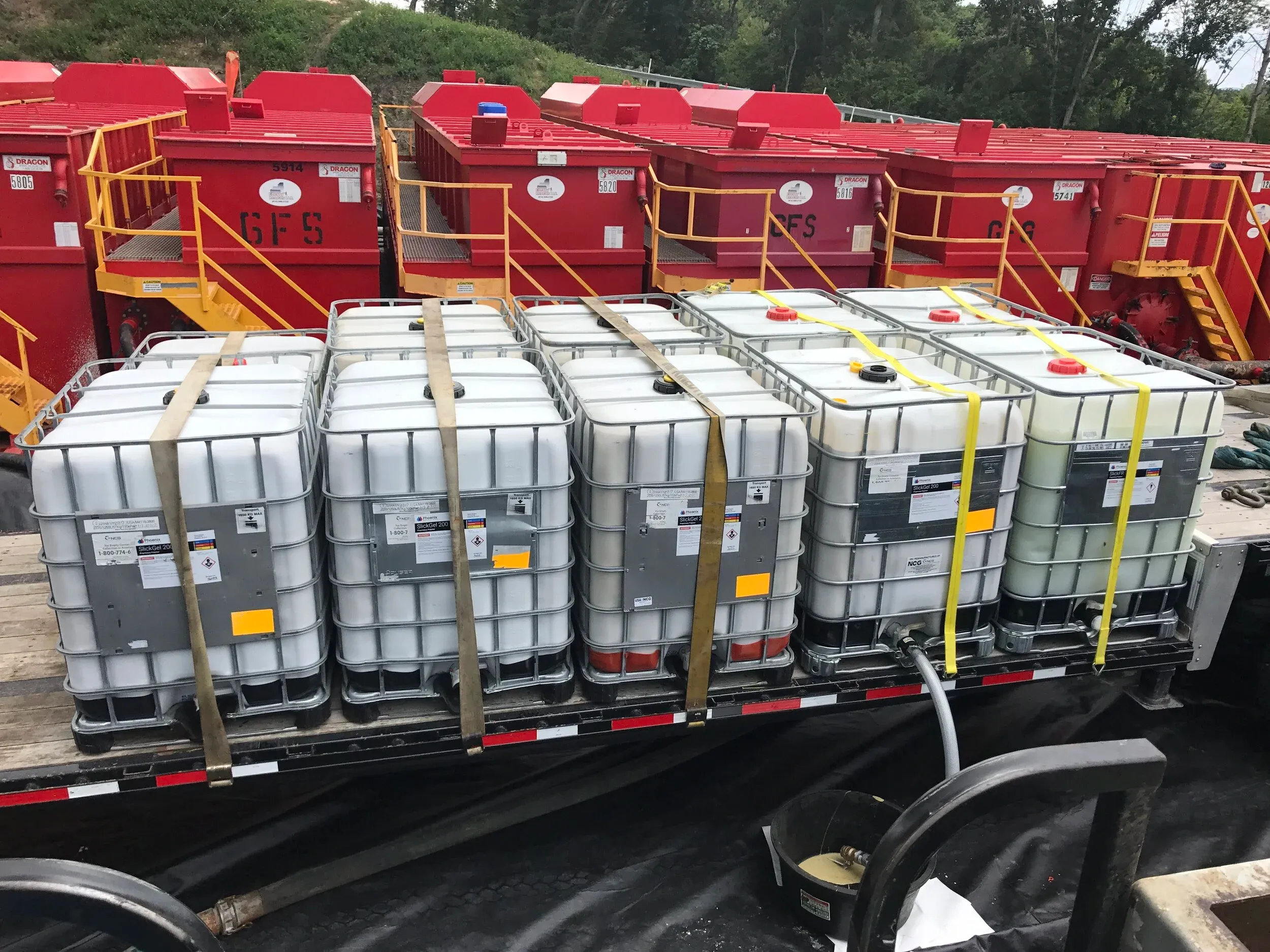 Chemical totes staged on location at a natural gas well site