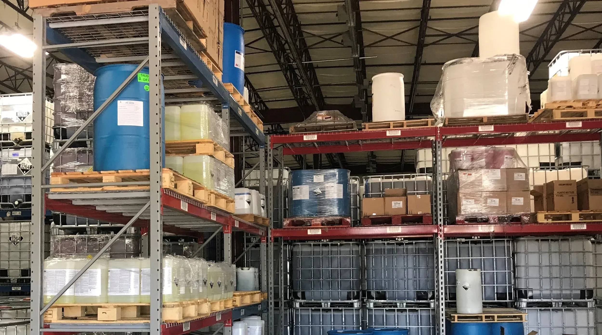 Racked drums and totes inside the Phoenix Solutions warehouse